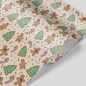 May include: Wrapping paper featuring a festive pattern of gingerbread people, Christmas trees, and candy canes in red, green, and brown on a tan background. The paper is rolled at the corner.