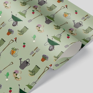 May include: A green and white gardening themed wrapping paper with a repeating pattern of gardening tools, flowers, boots, wheelbarrows, and birds.