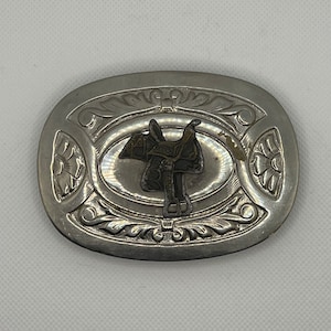 Silver belt buckle with saddle