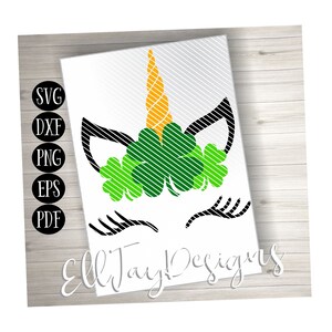 May include: A black and white unicorn face with a green shamrock headband. The unicorn's horn is yellow and the shamrocks are striped with green and white.