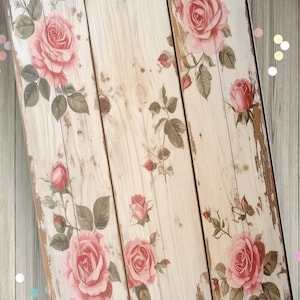 May include: A rectangular journal cover featuring a light-colored wood plank pattern with a distressed finish. The surface is decorated with illustrations of pink roses and green leaves. The text "Ugly Leather Journals" is printed in the corner.