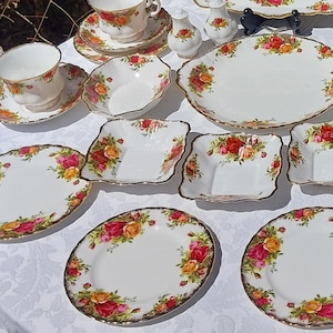 Puede incluir: Un juego de tazas de té, platillos y platos de porcelana fina vintage con un patrón floral. El juego incluye una fuente para servir, una tetera y un azucarero.