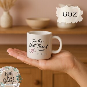 May include: A white ceramic mug with the text "To the Best Friend ever" and a heart graphic. The mug is 6 oz. and has a curved handle. The text "Love Sienna x" is also printed on the mug.