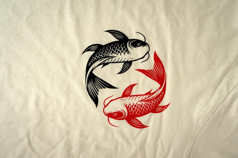K&ouml;nnte beinhalten: Ein cremefarbener Stoff zeigt ein Design mit schwarzen und roten Koi-Fischen. Die Fische sind in einem kreisf&ouml;rmigen Yin-Yang-Muster angeordnet, mit einem schwarzen und einem roten Fisch. Das Design ist eine stilisierte Illustration.
