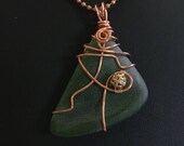 Green seaglass wire wrapped in copper with a gold bead accent