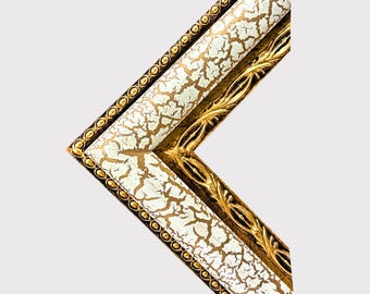 May include: A corner section of a picture frame featuring a white crackle finish on the outer edge, bordered by a beaded gold trim. The inner edge displays an ornate, raised gold leaf pattern, creating a contrast between the textured white surface.