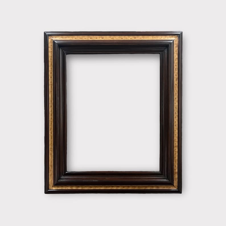 May include: A rectangular picture frame with a dark brown finish and a gold inner border. The frame has a classic, ornate design, suitable for displaying artwork or photographs. The frame is empty, with a white background visible.
