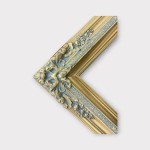 May include: A gold picture frame with a blue and gold ornate design. The frame has a decorative, carved edge.