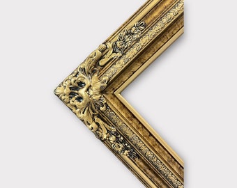 May include: A gold picture frame with ornate detailing and a black and gold finish.