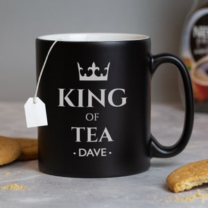 May include: Black ceramic mug with a white crown and the text "King of Tea .Dave."