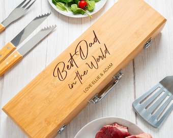 May include: A wooden box with a metal latch and handle. The box is engraved with the text "Best Dad in the World" and "Love Ellie & Adam".