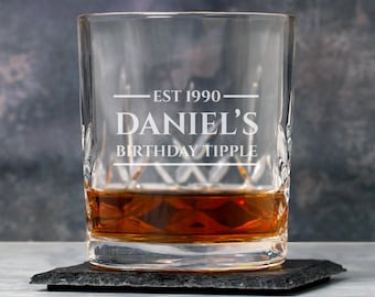 May include: A clear glass with a diamond pattern, filled with amber liquid. The glass is engraved with the text "EST 1990 - Daniel's Birthday Tipple".