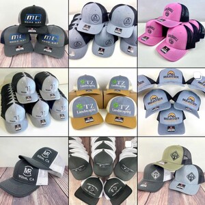 May include: Assortment of embroidered baseball caps in various colors and designs.  The caps feature logos and text such as "MC Wood Art", "Team", "TZ Landscaping", "Brightside", and "MR Wilton, CA".