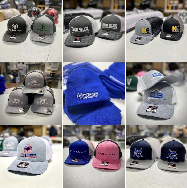 May include: A collection of various embroidered hats with different logos and designs. The hats are in different colors, including gray, black, blue, pink, and white. Some of the logos include "Patterson Plumbing", "13 Stripes", "Paragon", and "Count".