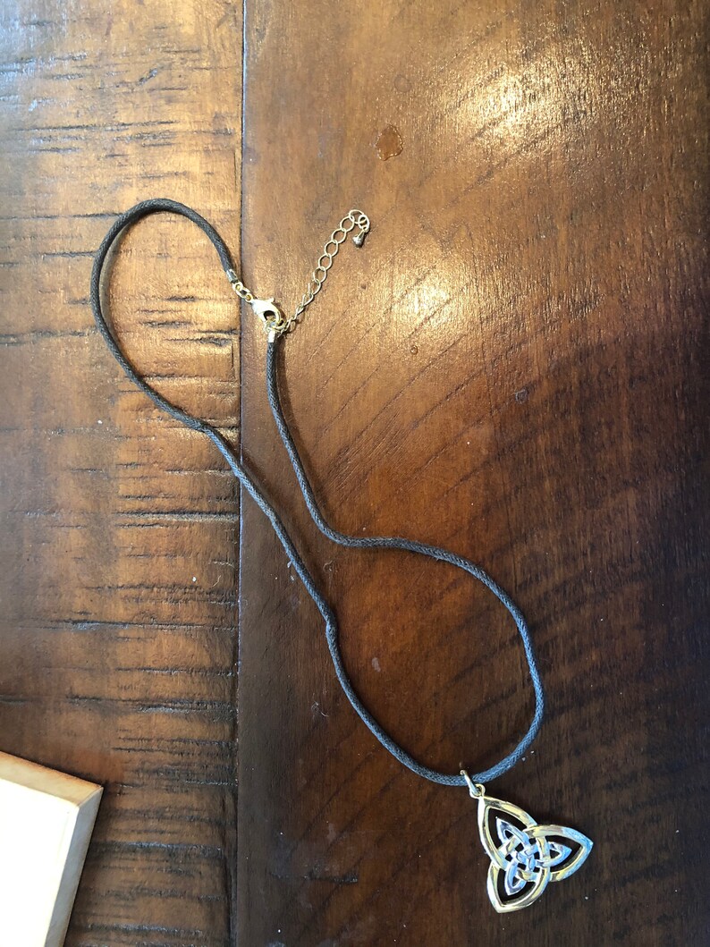 silver and gold trinity on a leather necklace band ...man or woman.. made in Ireland by solvar
