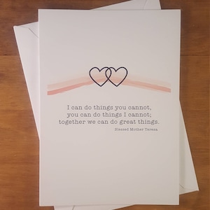 May include: A white card with a pink watercolor background and two intertwined hearts. The card features a quote by Blessed Mother Teresa: "I can do things you cannot, you can do things I cannot; together we can do great things."