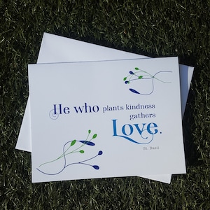May include: White card with blue and green floral designs and the quote "He who plants kindness gathers love. St. Basil"
