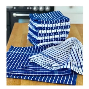 May include: A stack of blue and white checkered kitchen towels. The towels are folded and stacked on a wooden surface.