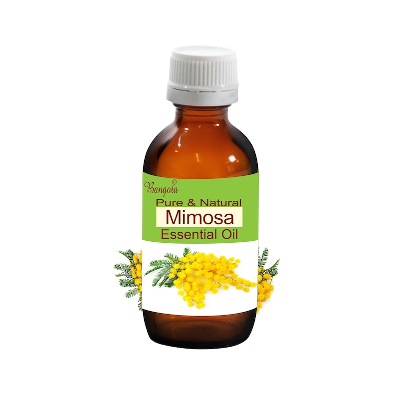 May include: A brown glass bottle with a white cap, labeled "Pure & Natural Mimosa Essential Oil." The label is green and white, with a mimosa flower illustration. The bottle is filled with a clear liquid.