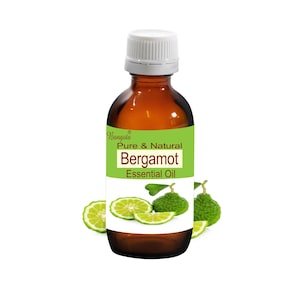 May include: A brown glass bottle with a white cap containing Bergamot Essential Oil. The label reads "Bangota Pure & Natural Bergamot Essential Oil". The bottle is surrounded by green bergamot fruit slices.