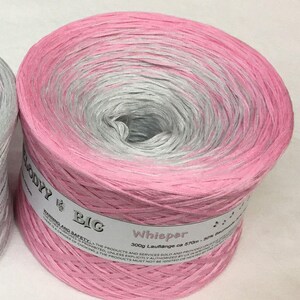 May include: A pink and gray yarn ball with the label "Whisper 300g Lauflange ca 570m - 50% Baumwolle" and the brand name "Glody Big".