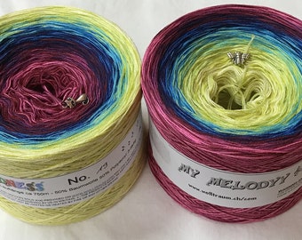 May include: Two skeins of yarn in a gradient color pattern. The skein on the left is yellow, green, blue, and pink. The skein on the right is pink, blue, green, and yellow. Both skeins have a label that says "My Melody" and "No. 73".