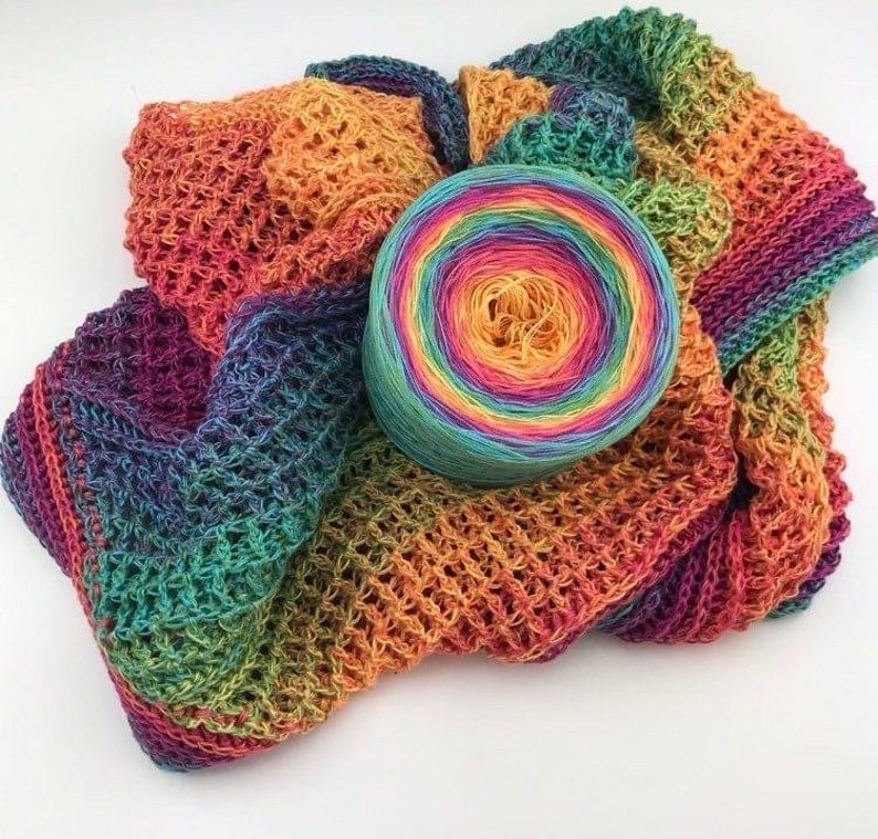May include: A rainbow colored yarn ball with a crocheted scarf made from the same yarn.