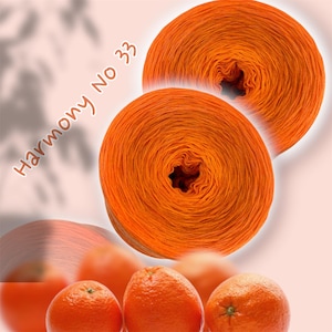 May include: Two bright orange yarn skeins, labeled "Harmony No 33", are the focal point of this image. The yarn is tightly wound, showcasing a gradient of orange hues. Below, several oranges are visible, complementing the yarn's color. The background is a soft pink.