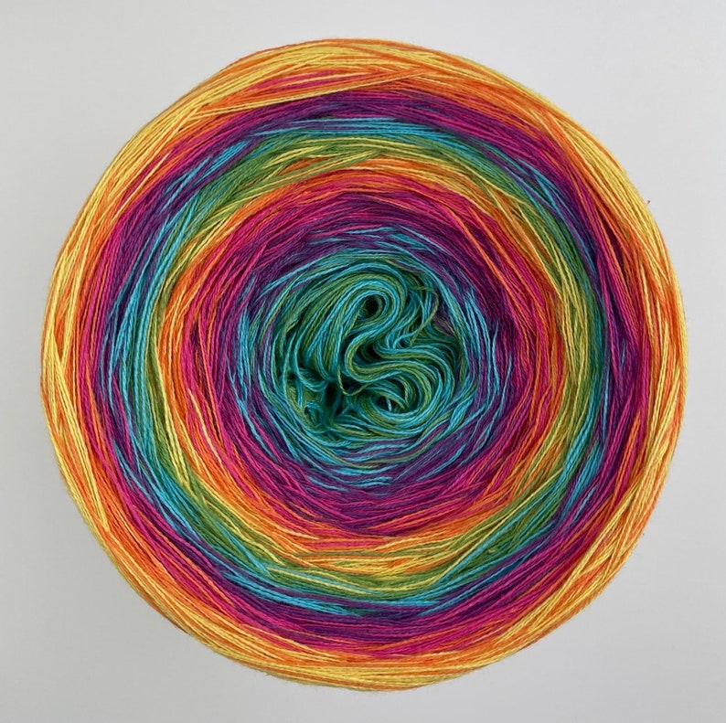 May include: A ball of yarn with a rainbow of colors, including yellow, orange, red, purple, blue, green, and teal.
