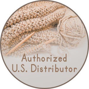May include: Circular image featuring a close-up of beige knitted fabric, knitting needles, and a ball of yarn. The text "Authorized U.S. Distributor" is displayed in a brown font.