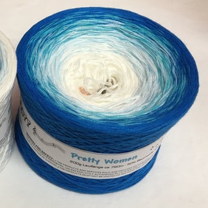 May include: A skein of blue, white, and turquoise yarn with the text "Pretty Women 200g Lauflange ca 760m - 50% Baumwolle" on the label.