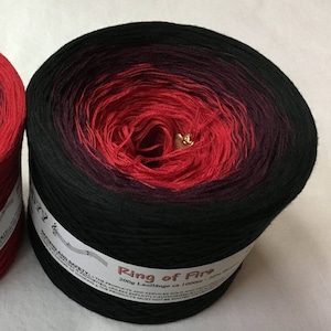 May include: A skein of black and red gradient yarn called "Ring of Fire". The yarn is 200 grams and 1000 meters long.