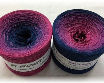 May include: Two skeins of ombre yarn, one in shades of pink and blue labeled "My Melody" and the other in shades of pink and blue labeled "Sweet Caroline".