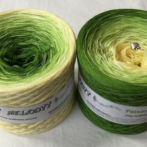 May include: Two skeins of yarn, one in a green to yellow ombre and the other in a yellow to green ombre. The skeins are labeled "My Melody" and "Poison".