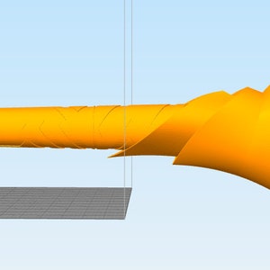 May include: A 3D printed model of a yellow, abstract, organic shape with a long, thin, cylindrical base. The shape is reminiscent of a stylized bird or a futuristic weapon.