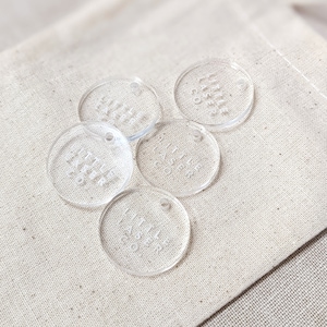 May include: Five clear acrylic round tags with the text "Little Rascals" on each tag.