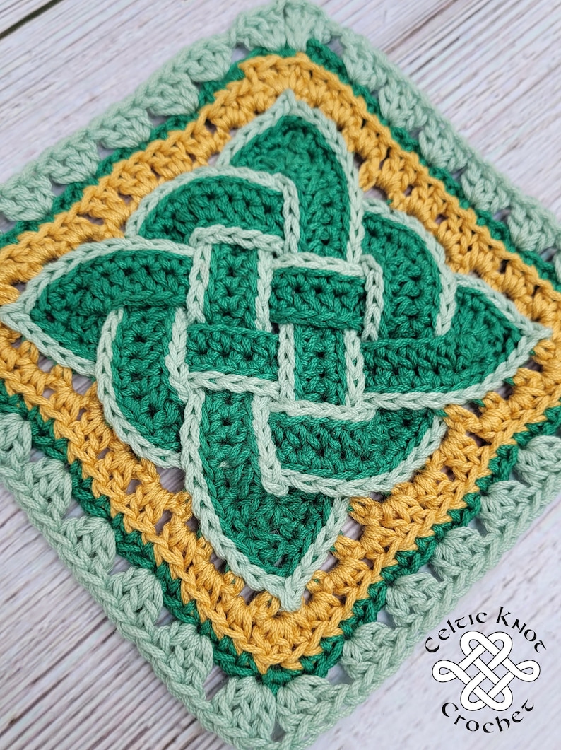 May include: A green, yellow, and light green crochet square with a Celtic knot design. The square is framed with a border of alternating single and double crochet stitches.