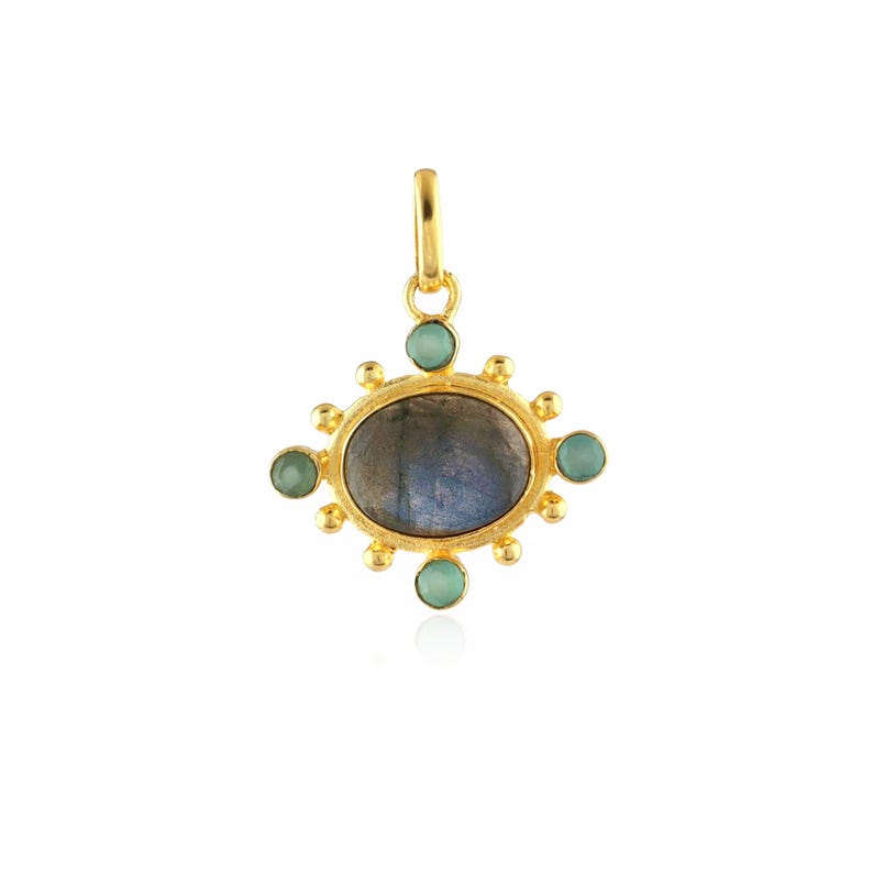 May include: A gold-colored pendant with an oval, gray-blue stone at the center, surrounded by small, round, light green stones. The pendant has a loop at the top for hanging.