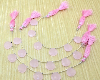 May include: A strand of pink rose quartz gemstone beads with silver spacers and pink tassel accents. The beads are round and have a smooth, polished finish.
