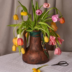 A vase in the form of an ancient Greek amphora with glass beads. Antique decor, ancient Greek style. A gift for a historian, archaeologist