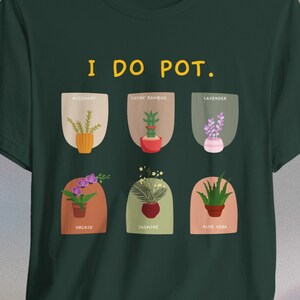 May include: Dark green t-shirt with the text "I DO POT." and illustrations of potted plants including rosemary, lucky bamboo, lavender, orchid, jasmine, and aloe vera. The design features a playful, botanical theme.