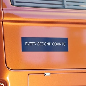 May include: A blue bumper sticker with white text that reads "EVERY SECOND COUNTS" on a bright orange vintage van.