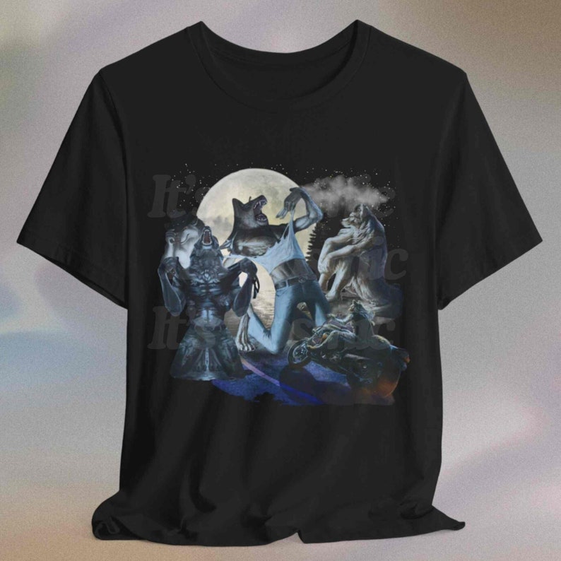 May include: Black t-shirt with a graphic depicting werewolves transforming under a full moon. The design shows several werewolf figures in different stages of transformation, with the text "It's" visible on the left side of the shirt.