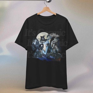May include: Black t-shirt with a graphic of werewolves under a full moon. The design includes the text "It's Cosmic". The artwork depicts several werewolf figures in a fantasy setting.