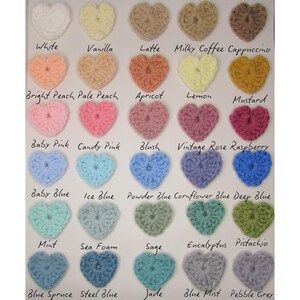 May include: A collection of crochet heart shapes in various colors, including white, pink, blue, and green. Each heart is labeled with its color name, such as "White," "Baby Pink," and "Mint." The image showcases a range of hues and shades.