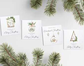 May include: Four square Christmas cards with watercolor illustrations and text. Designs include a window scene, a snow globe with a tree, a snow globe with stars, and a Christmas tree. Each card says "Merry Christmas".