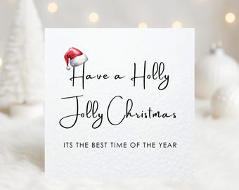 May include: A white Christmas card with the text "Have a Holly Jolly Christmas" in elegant script, accompanied by a watercolor Santa hat illustration. The phrase "ITS THE BEST TIME OF THE YEAR" is also included.