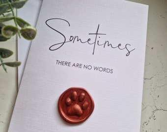 May include: A white card with the text "Sometimes there are no words" in black script. A copper-colored paw print wax seal is on the card.