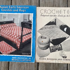 May include: Two vintage instructional booklets for needlework. The left blue booklet is titled Quaint Early American Coverlets and Rugs, featuring a red and white bedspread. The right cream booklet is titled Crocheted Bedspreads and other Articles for the Home, displaying a ball of Daisy mercerized crochet cotton.