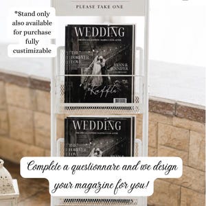 May include: A white metal tiered display stand featuring a sign that reads THE WEDDING EDIT PLEASE TAKE ONE. The stand holds multiple copies of a black and white magazine titled WEDDING THE SPECIAL EDITION HAPPILY EVER AFTER RYAN & JENNIFER.